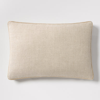 Tan velvet gusseted and linen lumbar pillow, 20"L x 14"H, with piped edges.