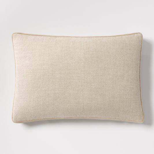 Tan velvet gusseted and linen lumbar pillow, 20"L x 14"H, with piped edges.