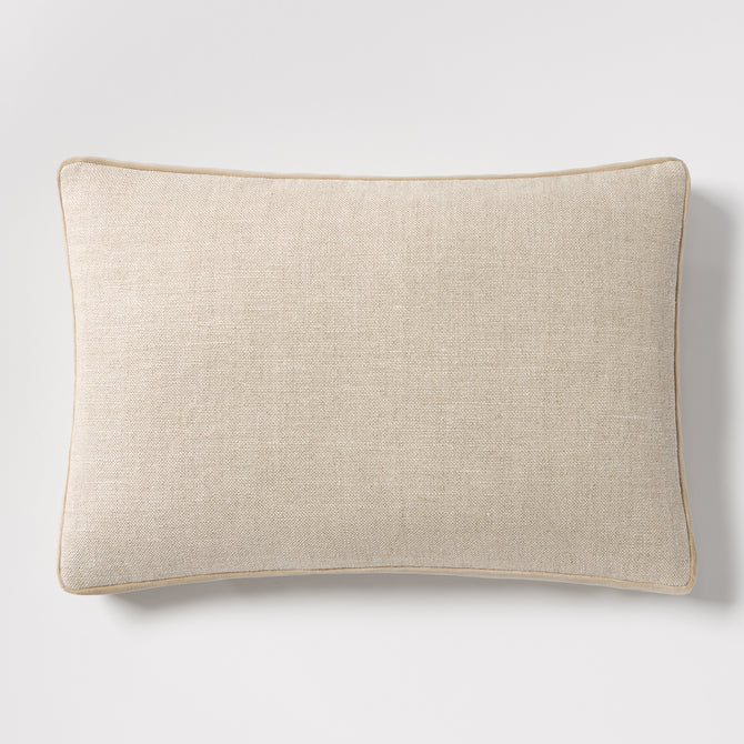 Tan velvet gusseted and linen lumbar pillow, 20"L x 14"H, with piped edges.