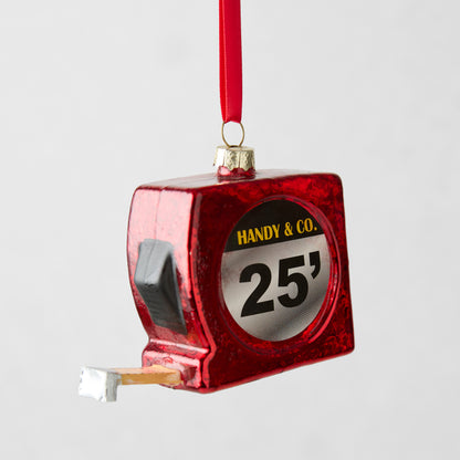 Red glitter glass tape measure Christmas ornament with "HANDY & CO. 25'" label.