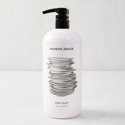 White HG Tart Kumquat Dish Soap bottle with a black pump, featuring a stack of plates design.