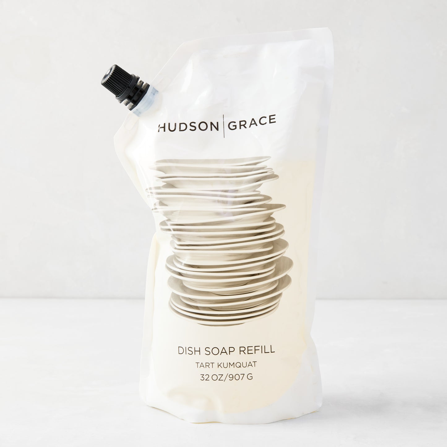 HG Tart Kumquat Dish Soap Refill Pouch, 32 oz, with stacked dishes graphic and black spout.