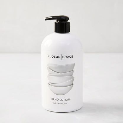 White HG Tart Kumquat Hand Lotion, 16 oz, with black pump and stacked bowls design.