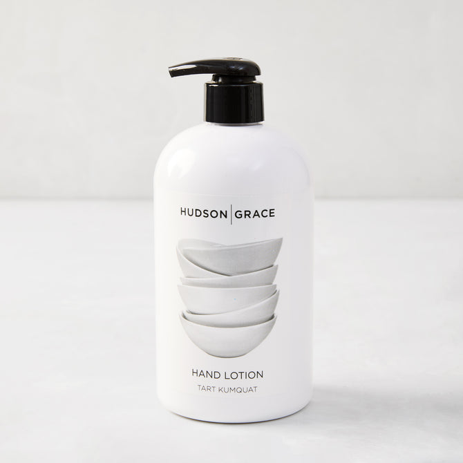 White HG Tart Kumquat Hand Lotion, 16 oz, with black pump and stacked bowls design.