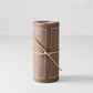 Taupe brown tear-off cotton cocktail napkin roll, tied with twine, featuring white dotted borders.