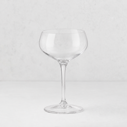 Clear glass Tavola coupe with a wide, shallow bowl and a slender stem on a white background.