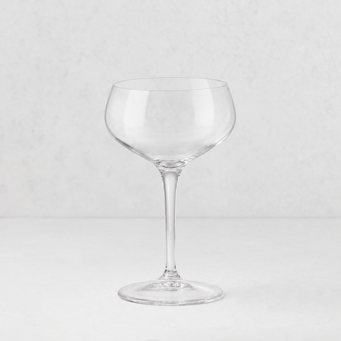 Clear glass Tavola coupe with a wide, shallow bowl and a slender stem on a white background.