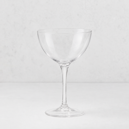 Clear glass Tavola martini coupe with a wide bowl and slender stem on a white background.