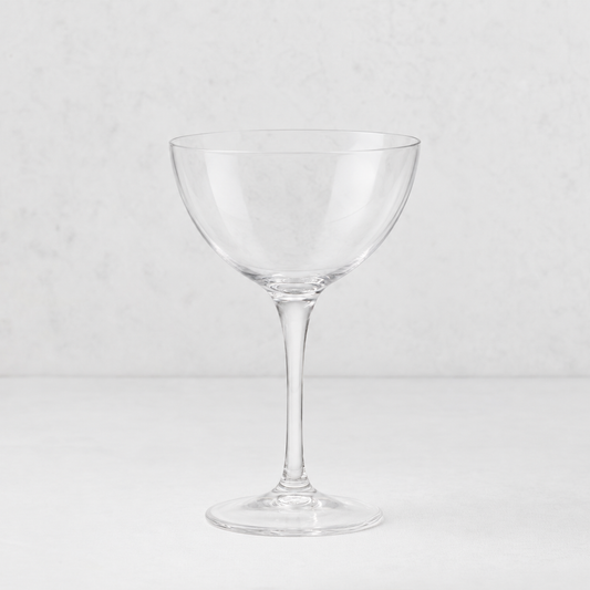 Clear glass Tavola martini coupe with a wide bowl and slender stem on a white background.
