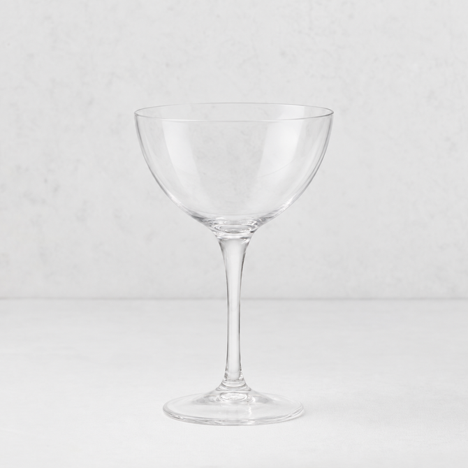 Clear glass Tavola martini coupe with a wide bowl and slender stem on a white background.
