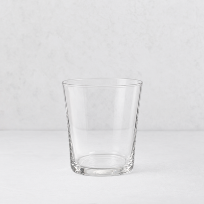 Medium Tavola tumbler made of clear, minimalist glass with a simple, tapered cylindrical design.