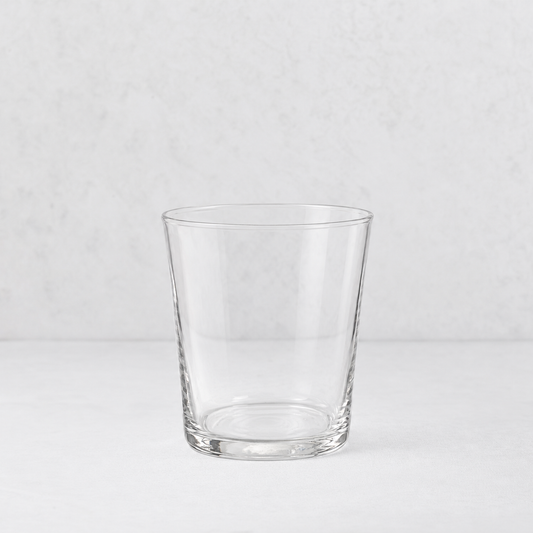 Medium Tavola tumbler made of clear, minimalist glass with a simple, tapered cylindrical design.