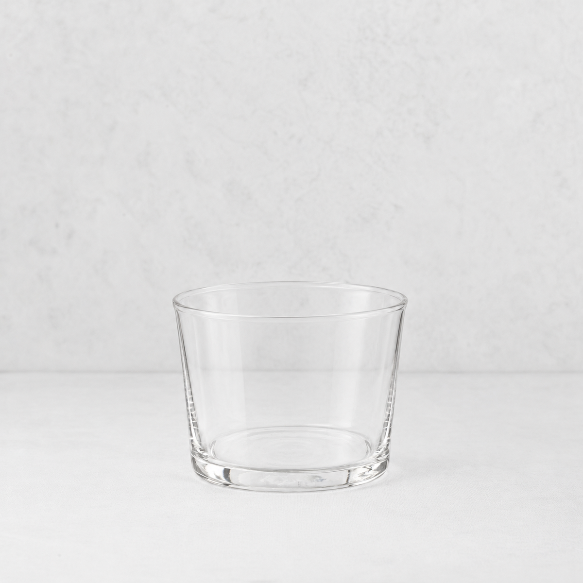 Clear glass Tavola mini tumbler with a simple, wide-rimmed design on a white surface.