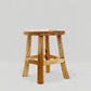 Handmade 17" reclaimed teak wood stool with natural grain and round seat.