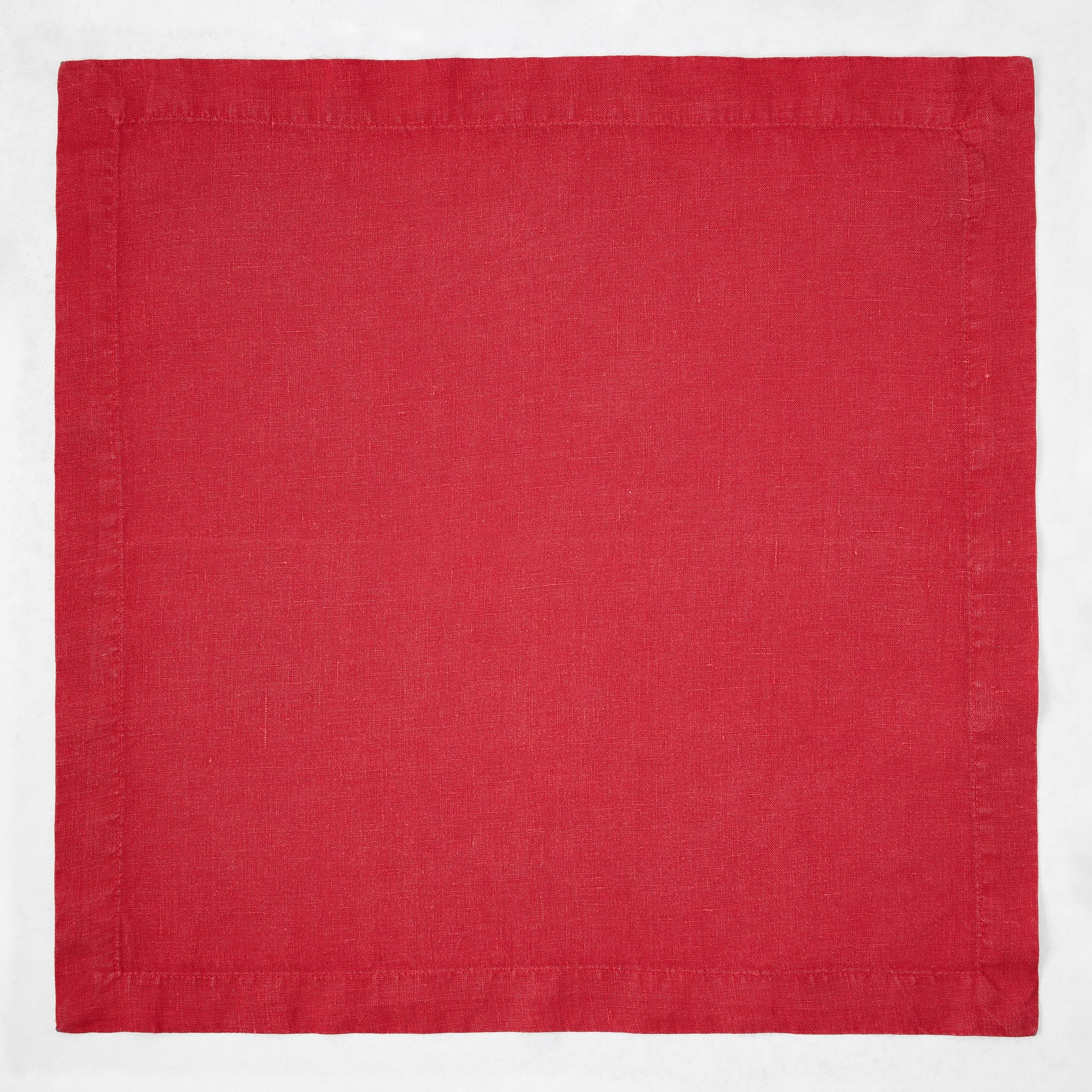 Flame red 22-inch square hand-dyed linen napkin with mitered corners.