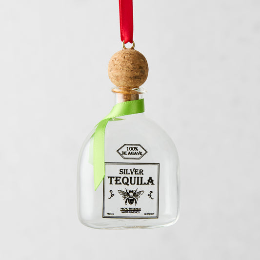 Glass tequila bottle Christmas ornament with cork top, red ribbon hanger, and green bow.