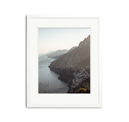 The Amalfi Framed Wall Art Print: picturesque Italian coast with white buildings, framed in white wood.