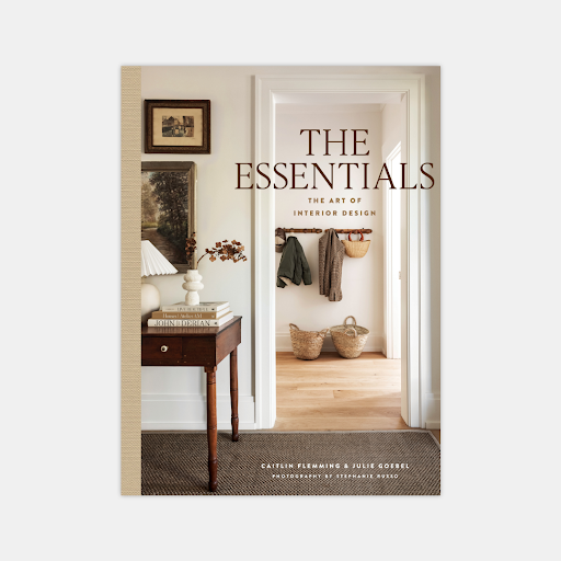 Hardcover book "The Essentials: The Art of Interior Design" by Caitlin Flemming, featuring a styled entryway.