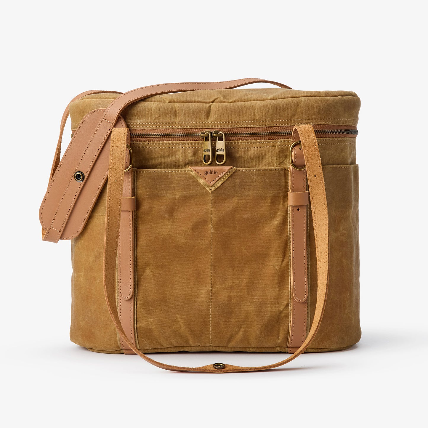 Goldie Picnic Bag: Tan waxed canvas insulated cooler with leather straps and gold zippers.