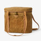 Goldie Picnic Bag: Tan waxed canvas cooler with leather straps and gold zipper, front pocket.