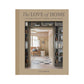 Hardcover book "The Love of Home" by Kate Marker, tan linen spine, interior design image on cover.