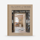 The Love of Home hardcover book with a beige cover featuring a photo of a curated interior design space.