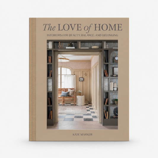 The Love of Home hardcover book with a beige cover featuring a photo of a curated interior design space.