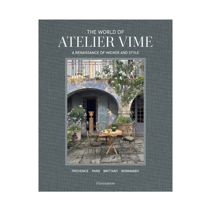 Hardcover book, "The World of Atelier Vime," gray linen cover with a courtyard scene.