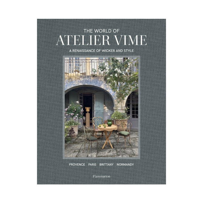Hardcover book, "The World of Atelier Vime," gray linen cover with a courtyard scene.