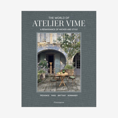 Hardcover book, "The World of Atelier Vime," gray linen cover with a courtyard scene.