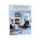 Hardcover "This is Home" book with a light blue living room cover image, white sofa, and blue rug.