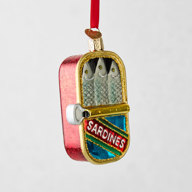 Hand-painted glass tinned sardines ornament, red with gold glitter, featuring three silver fish.