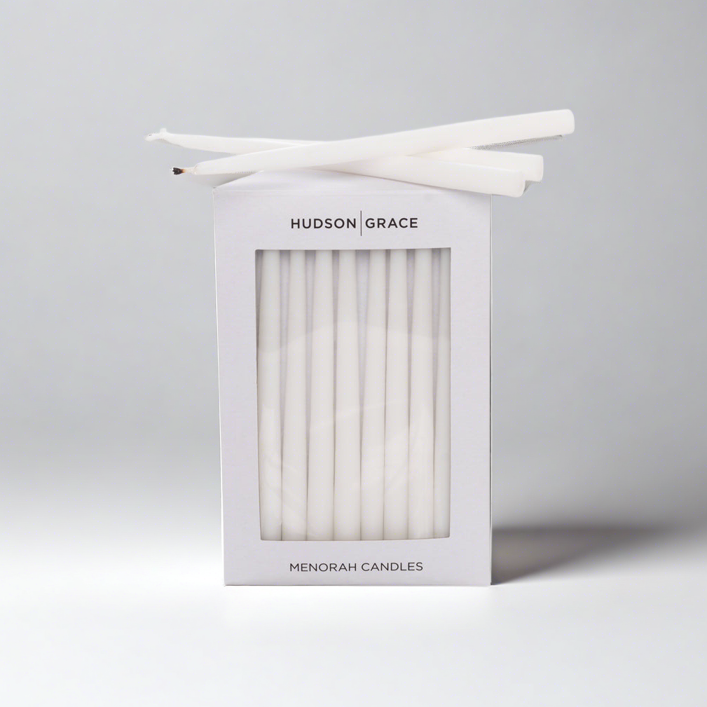 White Hudson Grace Menorah Candles box with a window, showing delicate, elongated paraffin tapers.