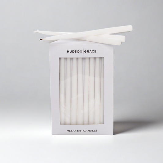 White Hudson Grace Menorah Candles box with a window, showing delicate, elongated paraffin tapers.