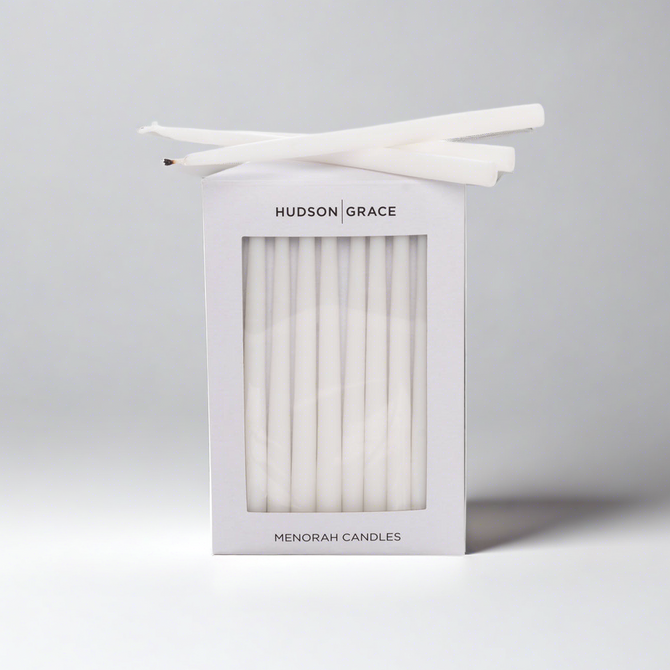 White Hudson Grace Menorah Candles box with a window, showing delicate, elongated paraffin tapers.