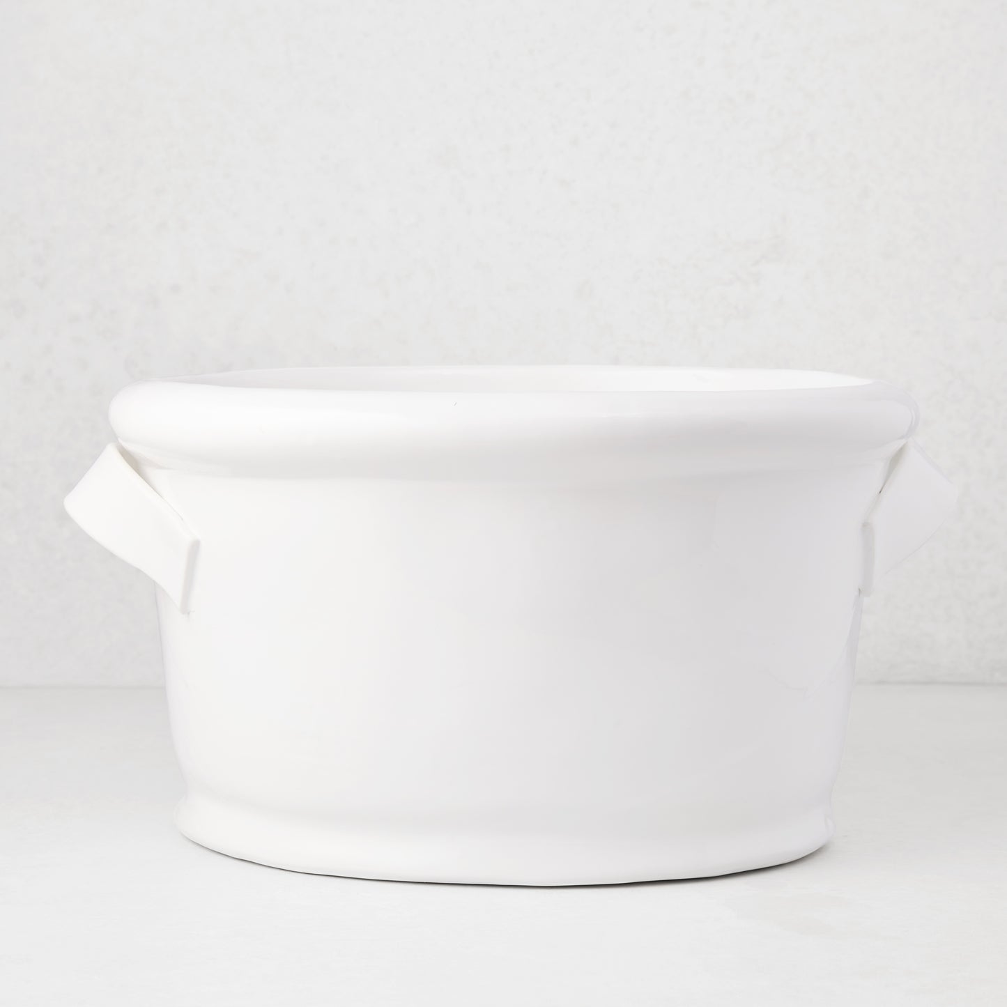 Tivoli white ceramic ice bucket with two simple handles, 17.3"L x 14"W x 9.4"H.