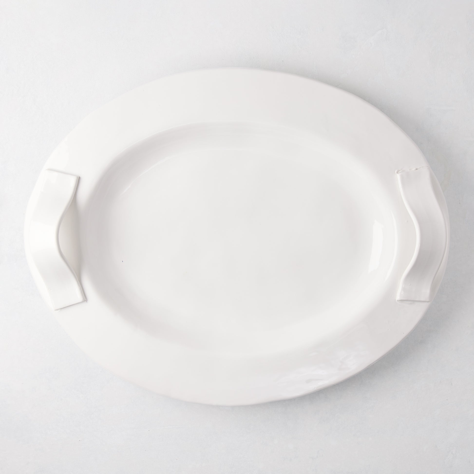 Tivoli white ceramic oval serving platter with two elegant handles.