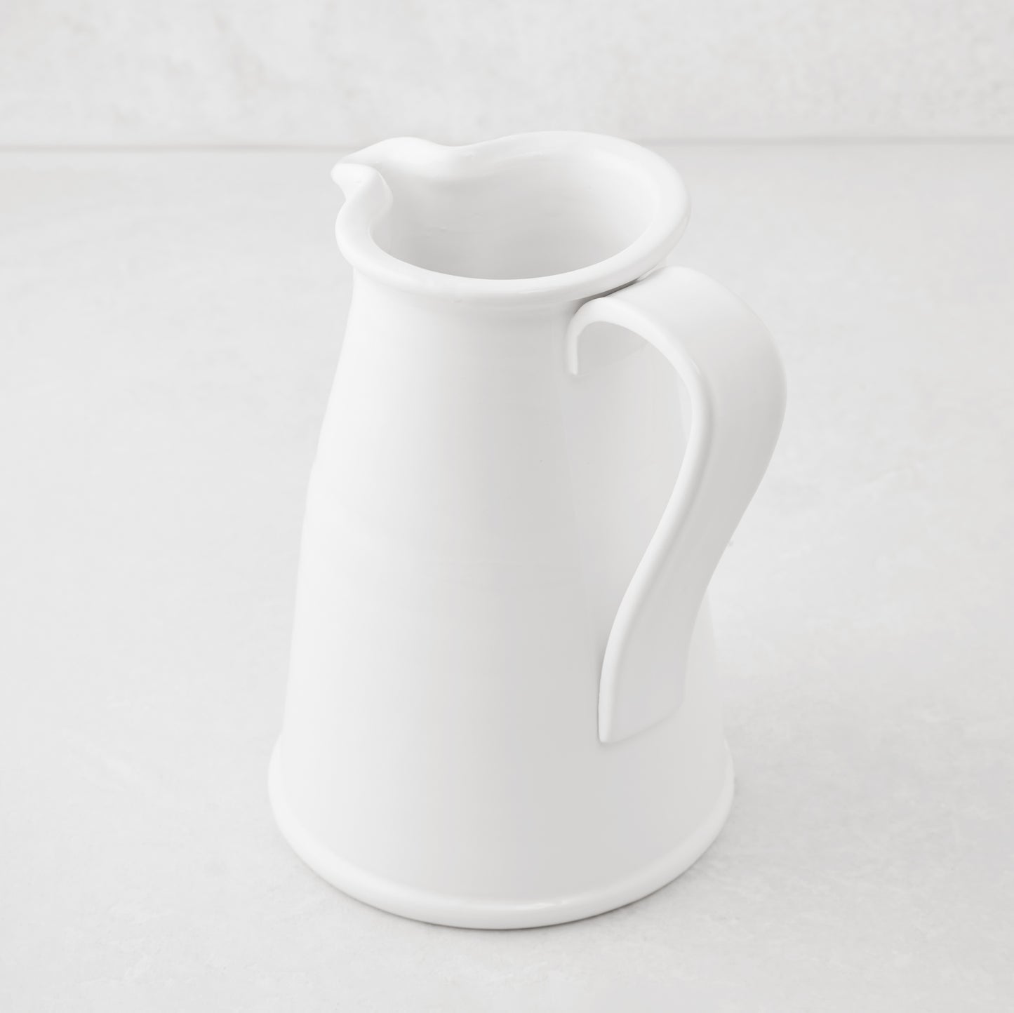 Tivoli white ceramic pitcher with flat handle, Italian craftsmanship.