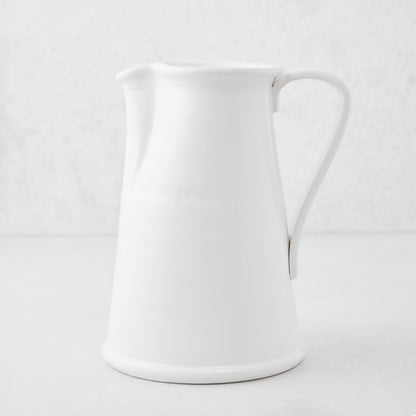 Tivoli white ceramic pitcher with a simple flat handle, 8.6"H.
