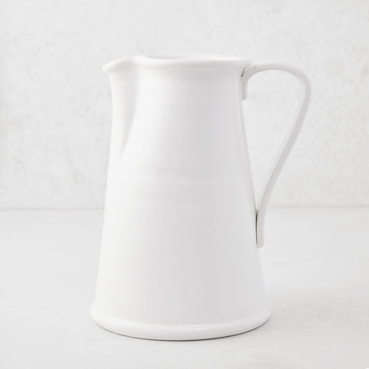 Tivoli white ceramic pitcher with a simple flat handle, 8.6"H.