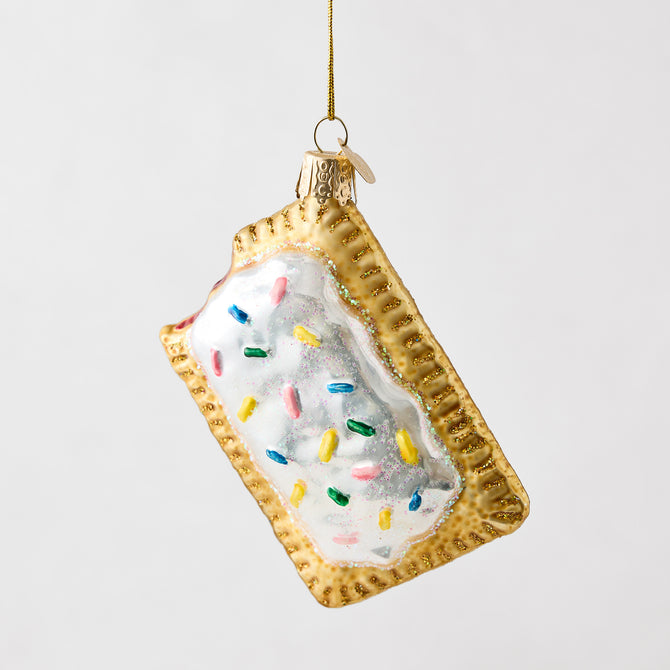 Hand-painted glass and resin toaster pastry ornament with white icing and colorful glitter sprinkles.