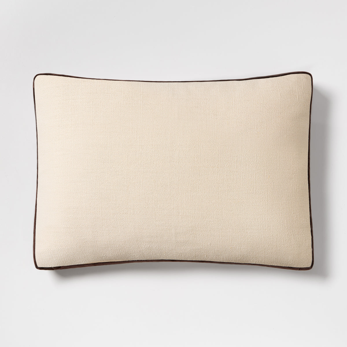 20x14 inch cream linen lumbar pillow with brown velvet gusset trim and flange detail.
