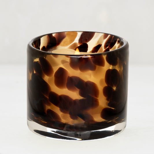 Tortoise votive glass candle holder with a lit tealight, 2.75"Dia x 2.75"H.