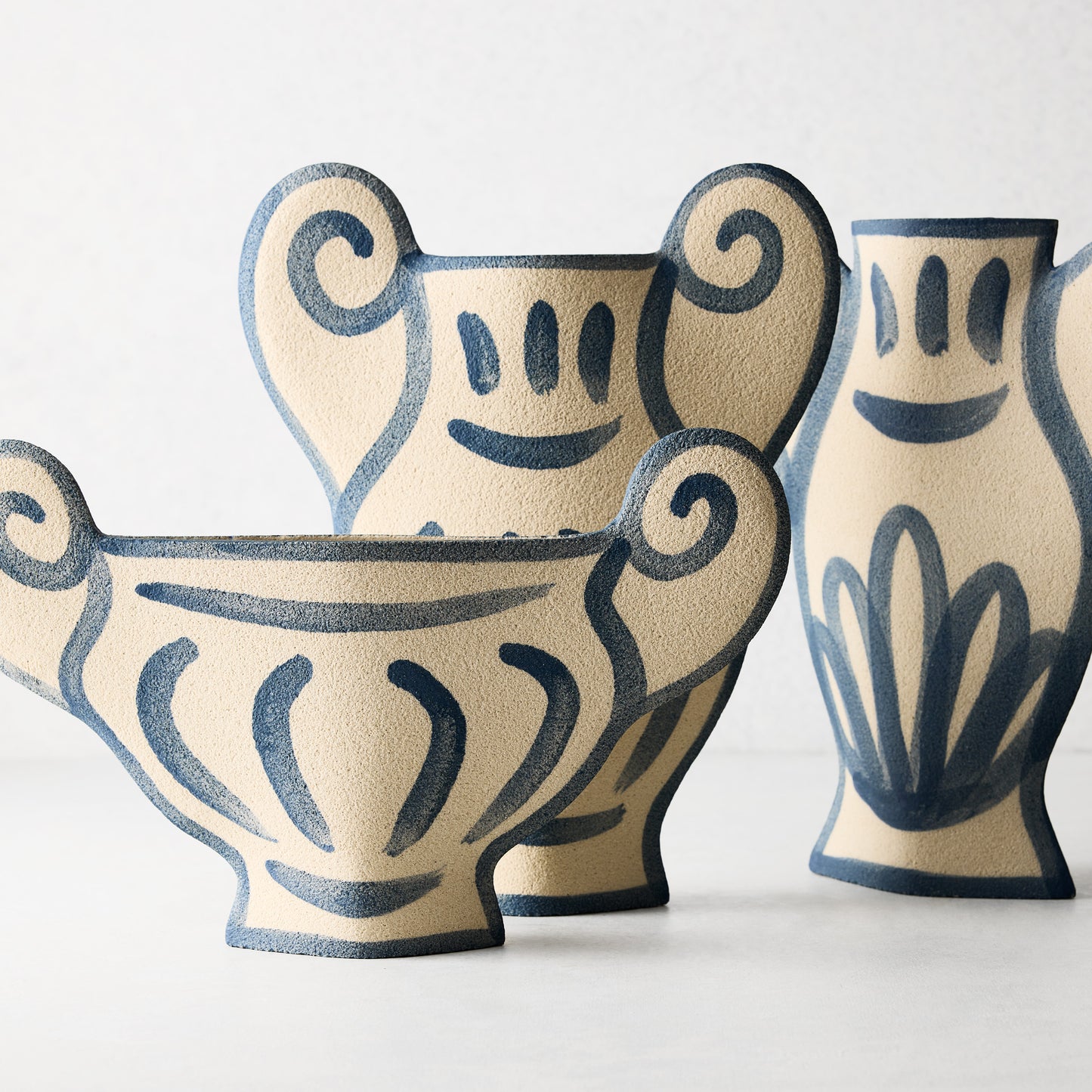Three Trompe-L'oeil Floral N2 Krater stoneware vases with blue hand-painted Greek-inspired designs.