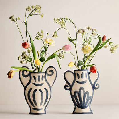 Two Trompe-L'oeil Greek Coupe Krater stoneware vases with blue detailing and colorful flowers.