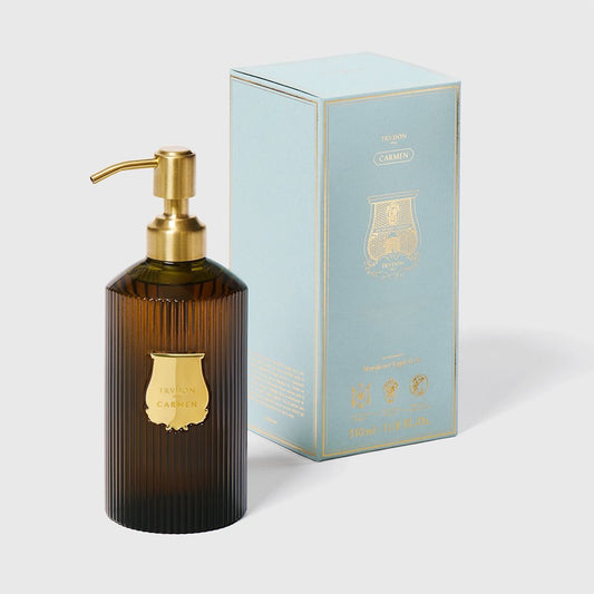 Trudon Carmen liquid hand soap in a ribbed dark amber glass bottle with a gold pump and label, beside a light blue box.