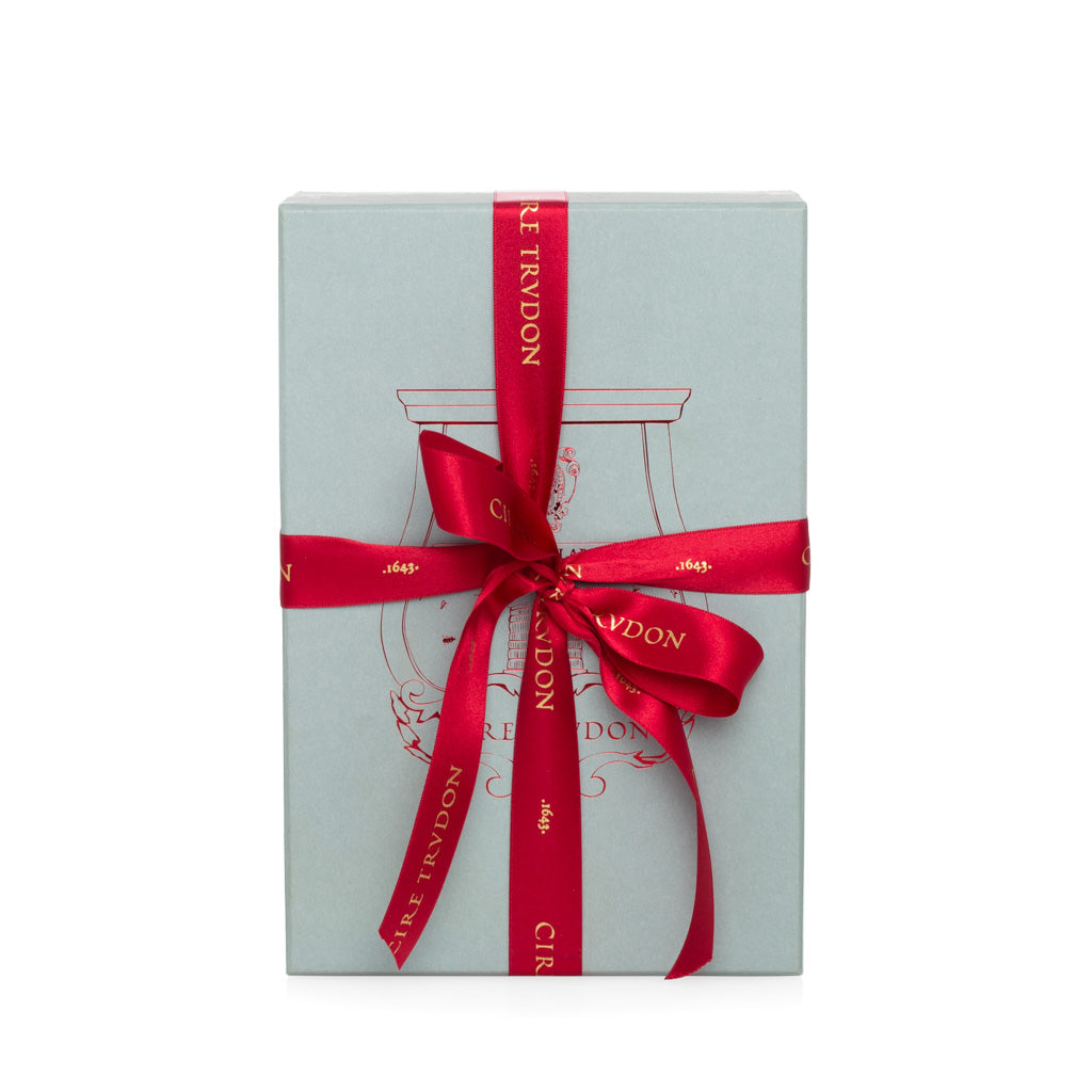 Trudon Cyrnos Scented Room Spray gift box, light blue with red ribbon and gold logo.