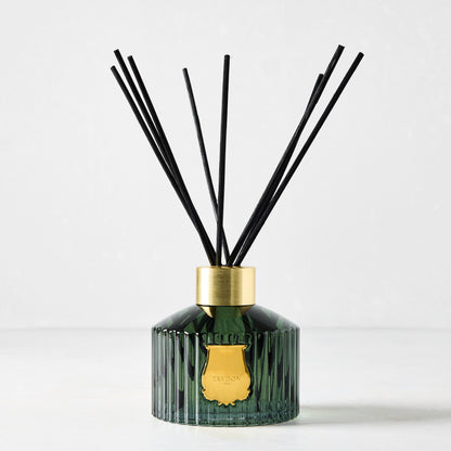 Trudon Figuerie Scented Reed Diffuser: dark green fluted glass, gold seal, black rattan sticks.