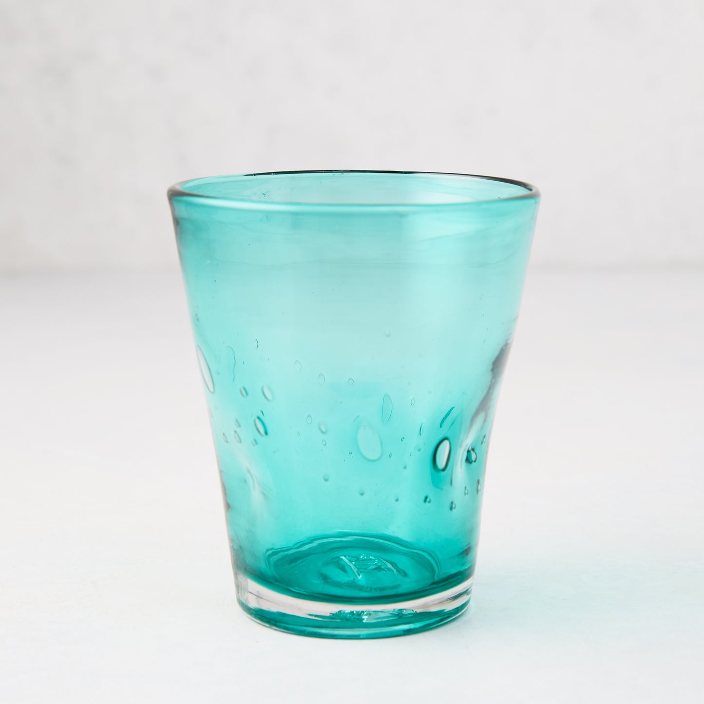 Turquoise Henri mouth-blown glass, 8 oz, with unique air bubbles and asymmetry.