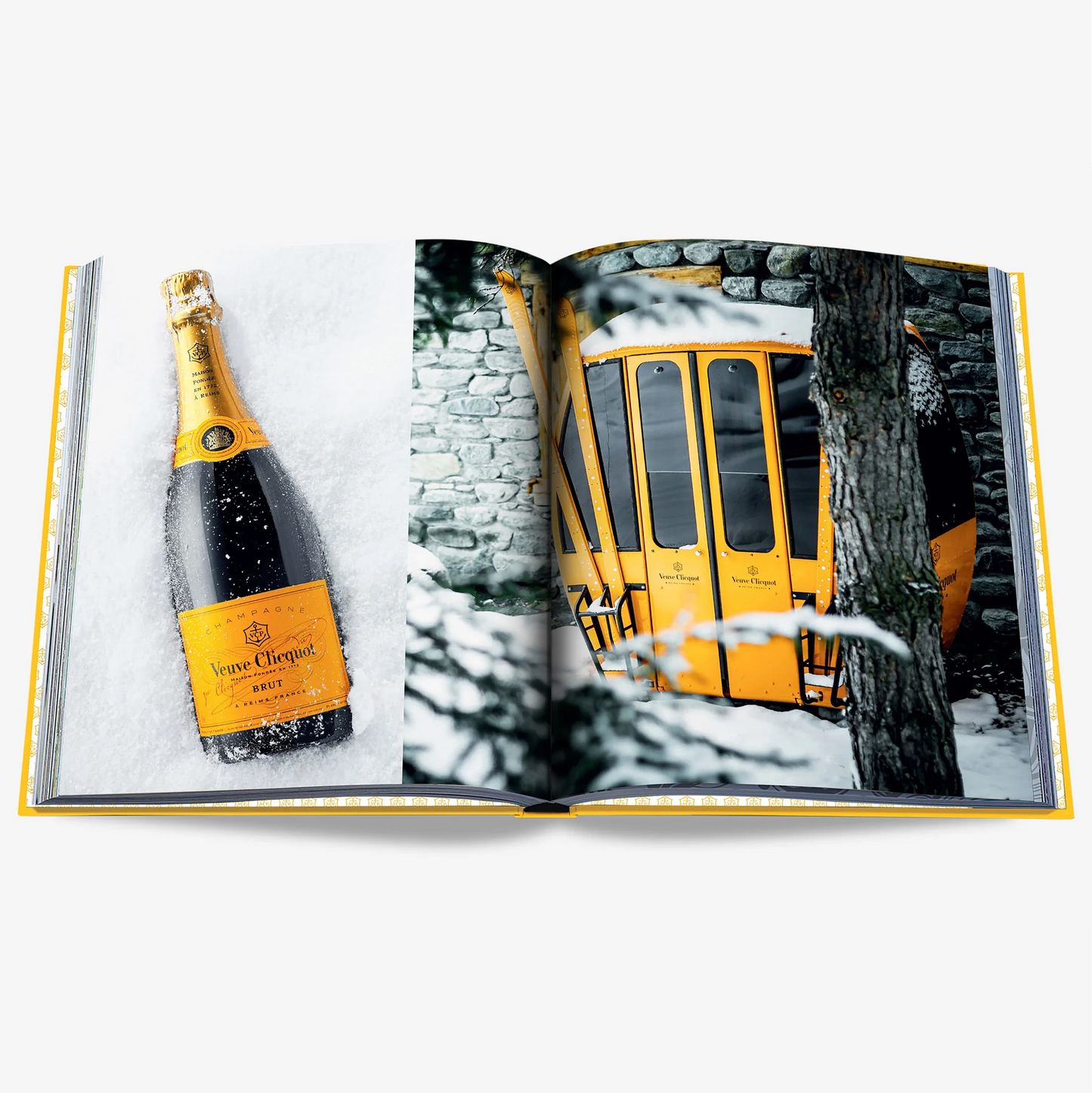 Open Veuve Clicquot Assouline hardback book with a champagne bottle and yellow ski gondola in snow.